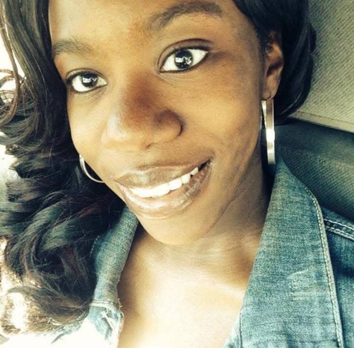 Chawnteeka, who has dark hair and wears silver earrings a jean jacket, smiles at the camera.