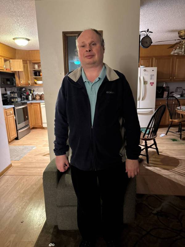 Jeremy stands in his living room.