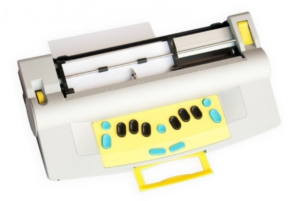 Mountbatten Whisperer is a white device with 6 black keys and 7 green keys for braille writing. The embosser is located at the top of the device.