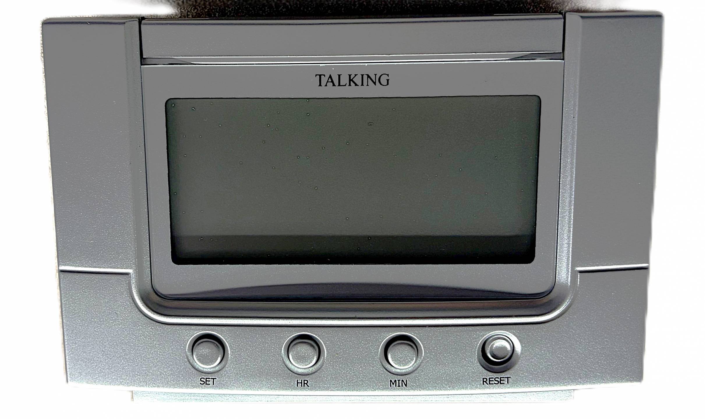Tapered talking clock with large LCD display, large top button for time, and four smaller setting buttons below the display