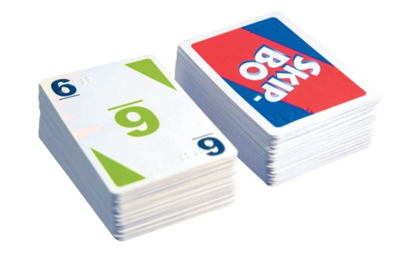 Skip-Bo card game with large colorful print and braille in the top left and bottom right corners.