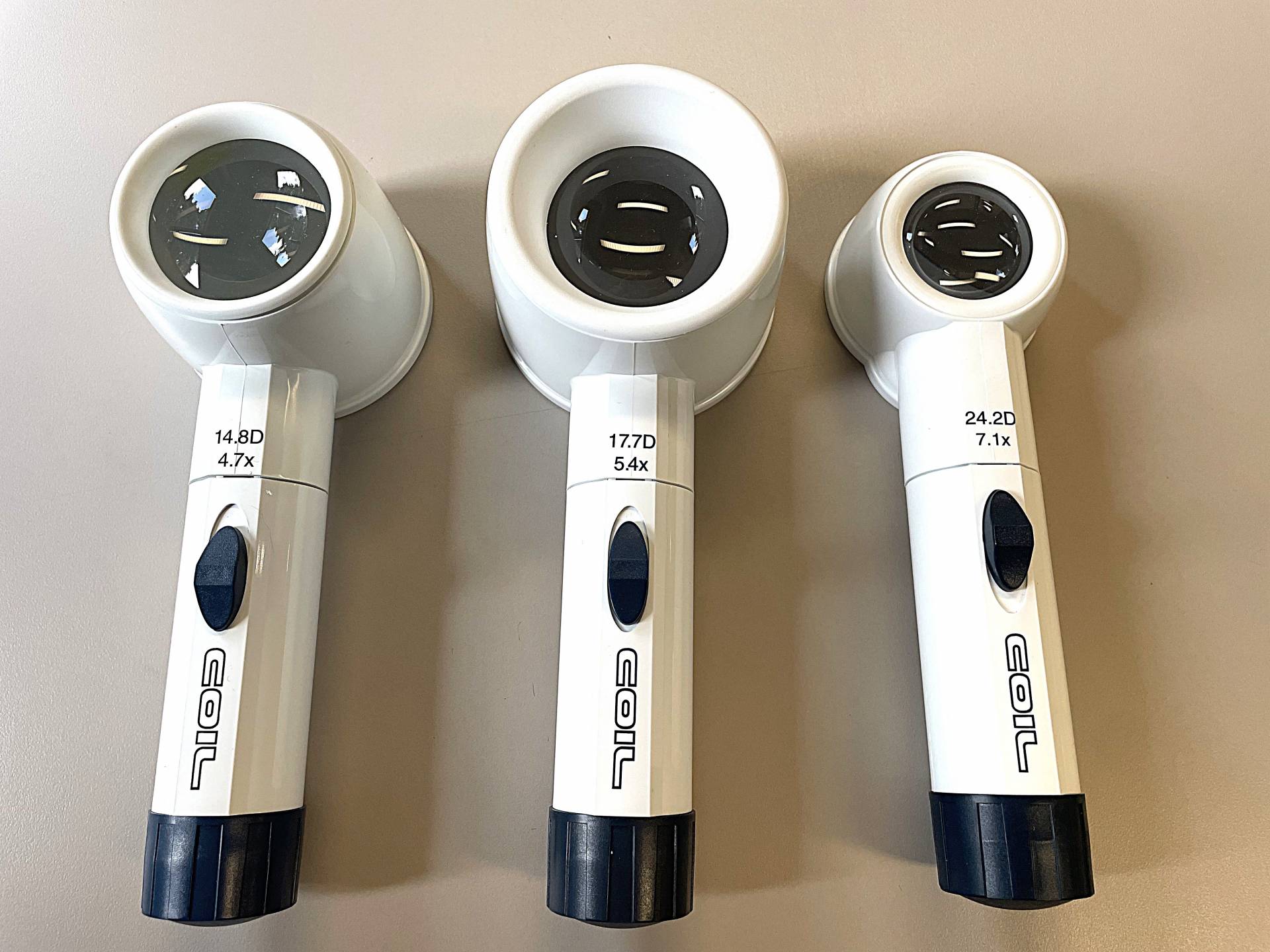 4.7x, 5.4x, and 7.1x magnifiers, all with large round lenses and long handles with a button for illumination