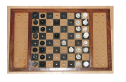 Tactile Chess Set, board has tan and black squares, pegs on each plastic playing piece and holes in the board hold each piece in place, plastic pieces are shaped differently; white pieces have a bump on top, and the white squares on the board are raised to help track board colors and diagonals