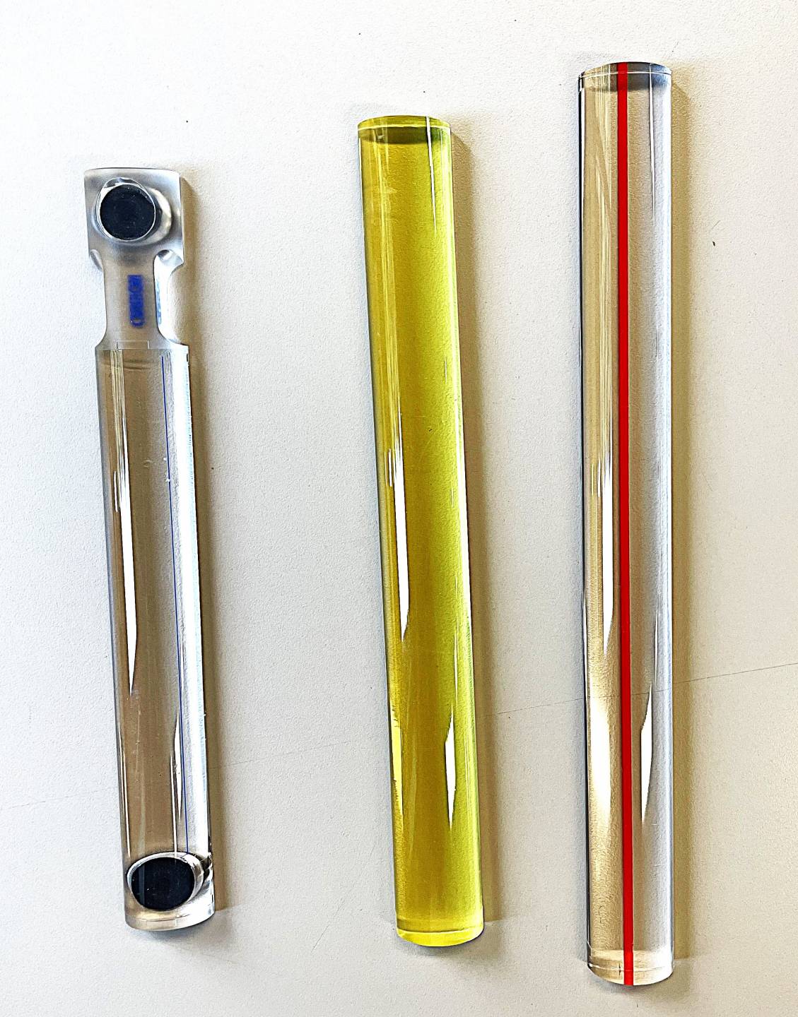 Clear 8 inch bar magnifier, Yellow 9 inch bar magnifier, clear 10 inch bar magnifier with red line down center