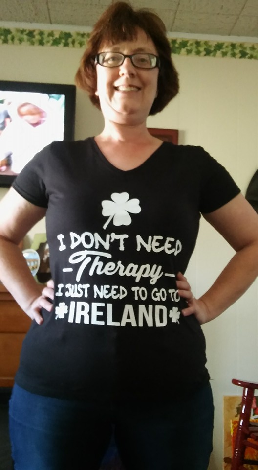 Mary stands proudly wearing a t-shirt that reads "I don't need therapy. I just need to go to Ireland."