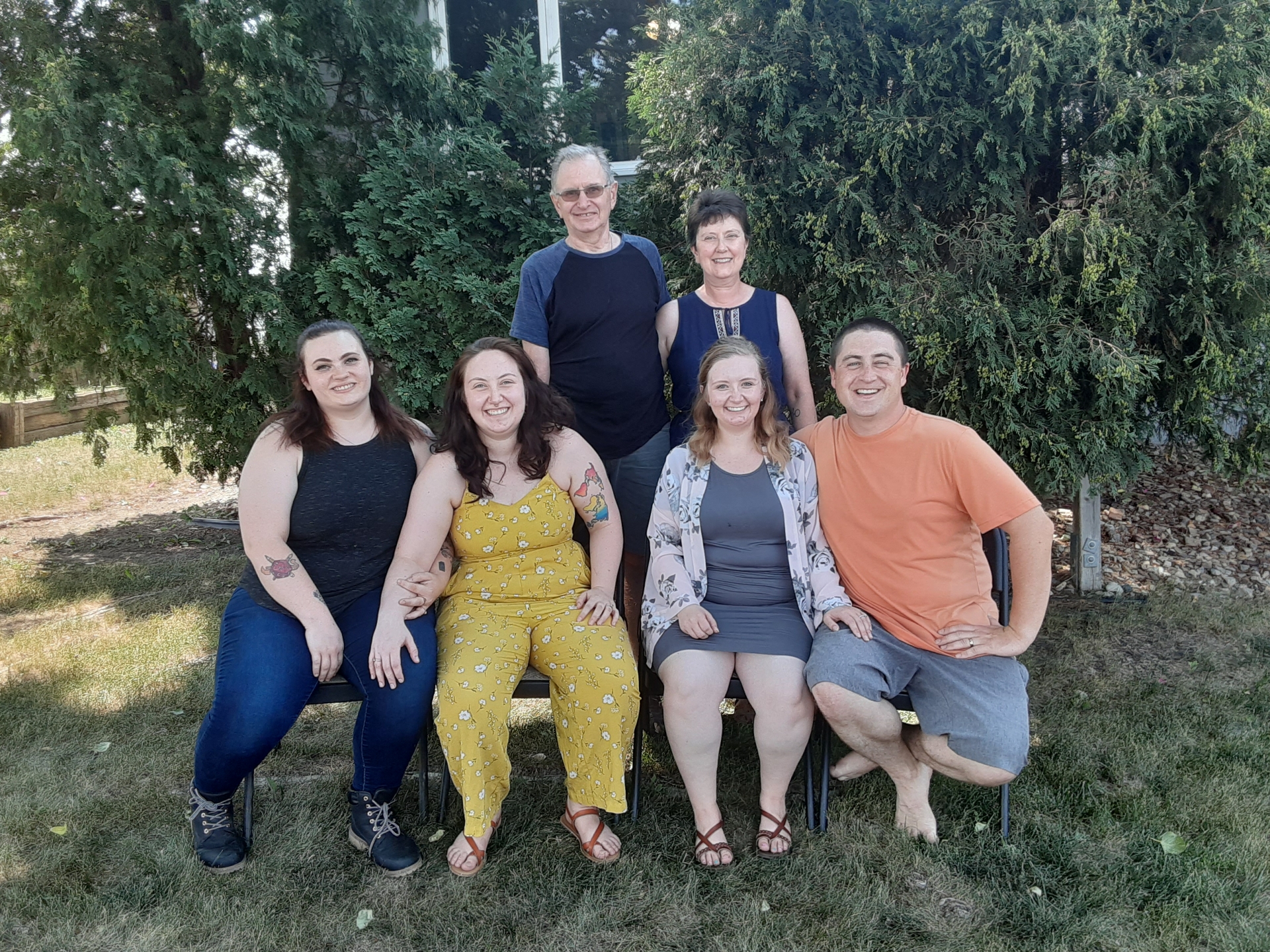 Mary and her family pose outdoors.