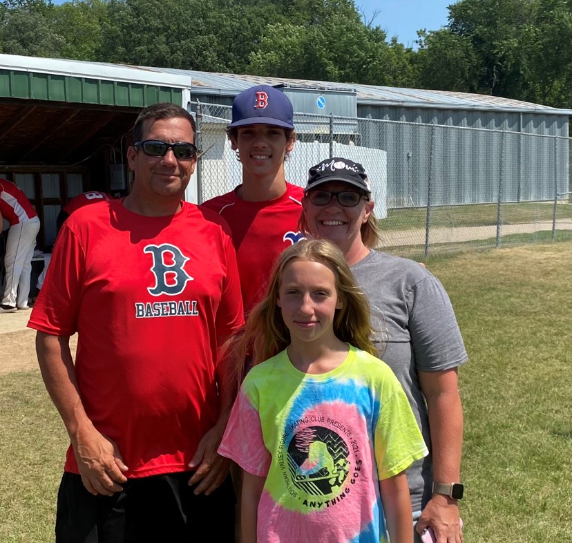 Melissa at a baseball game with Jeff, Gavin, and Tessa.