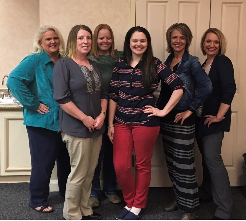 Melissa and 5 other women pose smiling for the camera.