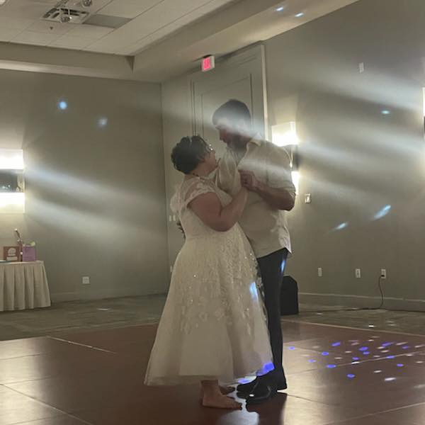 Elias and his new wife Kaity are dancing on their wedding day on a dance floor.